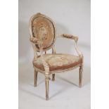 A C19th painted French elbow chair with carved details, fluted legs and embroidered seat and back,