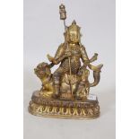 A gilt bronze figure of a warrior bearing a lance and seated upon a kylin, 11" high