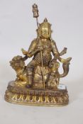 A gilt bronze figure of a warrior bearing a lance and seated upon a kylin, 11" high