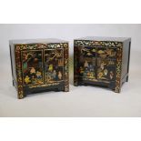A pair of Chinese black lacquer bed side chests, the doors with painted and gilt decoration of