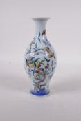 A doucai porcelain vase with peach tree and bat decoration, six character mark to base, 8" high