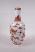 A Chinese red and white porcelain vase decorated with two dragons chasing the flaming pearl, with