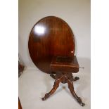 A Victorian mahogany tilt top breakfast table raised on a shaped column and four cabriole