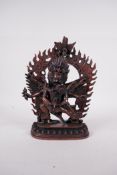 A Tibetan coppered metal figure of a wrathful deity and lover, impressed double vajra mark to