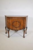 A 1920s walnut serpentine front side cabinet, with burr walnut inlaid top and carved edge over a
