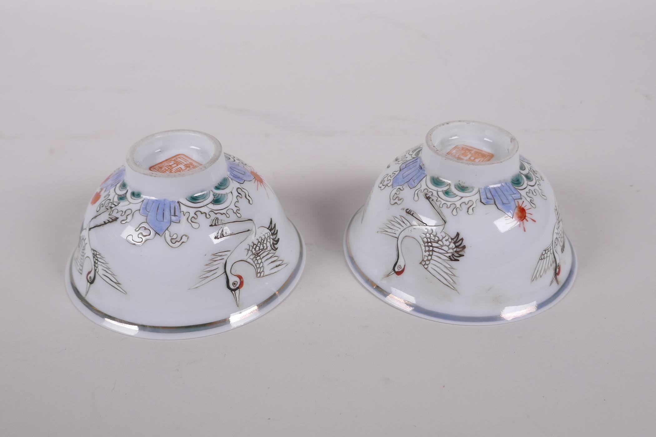 A pair of early C20th Chinese polychrome porcelain tea bowls decorated with cranes, seal mark to - Image 5 of 6