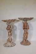 A matched pair of antique carved wood floor standing putti holding aloft clam shells, 43" high
