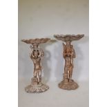 A matched pair of antique carved wood floor standing putti holding aloft clam shells, 43" high