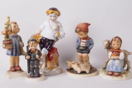 Four Goebels 'Hummel' figurines, 'Farm Boy, 5" high, a German porcelain figure of a boy leaning on a