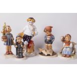 Four Goebels 'Hummel' figurines, 'Farm Boy, 5" high, a German porcelain figure of a boy leaning on a