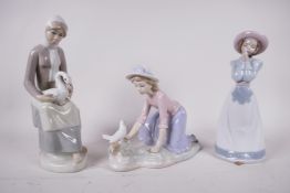 Two Nao porcelain figurines, 'A girl praying', model number 1224, and 'A girl caressing a dove',