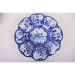 A petal shaped Delft pedestal tazza painted with waterside scenes, 12" diameter