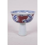 A Ming style blue and white porcelain stem cup with red carp decoration, Chinese, 3" high x 4"