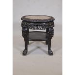 A C19th Chinese hardwood two tier table, with inset marble top, carved decoration and pierced