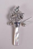 A sterling silver and mother of pearl baby's rattle in the form of a dog, 3½"