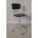 An industrial leatherette and chrome revolving desk chair, adjustable heights