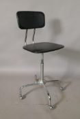 An industrial leatherette and chrome revolving desk chair, adjustable heights