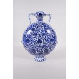 A blue and white porcelain two handled flask with lotus flower decoration, Chinese, 10" high