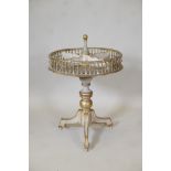 A C19th painted and parcel gilt revolving table, the four section top with pierced gallery, raised
