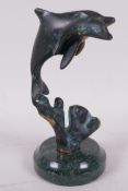 A bronze figure of two dolphins on a marble socle, 6" high