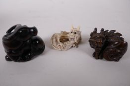 Two Japanese carved wood netsuke, a buffalo and dragon, and a carved ivory netsuke of a dragon