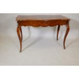 A French amboyne shaped top two drawer writing table, with inlaid decoration and inset figured walnt