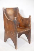 A planked elm lambing chair of small proportions showing signs of much use, and of unusual dowel and