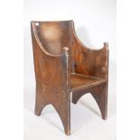 A planked elm lambing chair of small proportions showing signs of much use, and of unusual dowel and