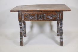 An Italian/Tyrolean fruitwood and poplar side table with plank top and single drawer, carved with