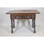 An Italian/Tyrolean fruitwood and poplar side table with plank top and single drawer, carved with