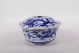 A Chinese blue and white porcelain steep sided bowl and cover decorated with dragons, six