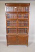 A mahogany Globe Wernicke style four tier bookcase on cupboard base, the upper section with lead