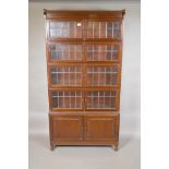 A mahogany Globe Wernicke style four tier bookcase on cupboard base, the upper section with lead