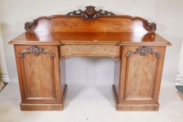 A Victorian mahogany twin pedestal sideboard with inverted front, and single frieze drawer between