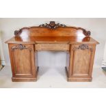 A Victorian mahogany twin pedestal sideboard with inverted front, and single frieze drawer between