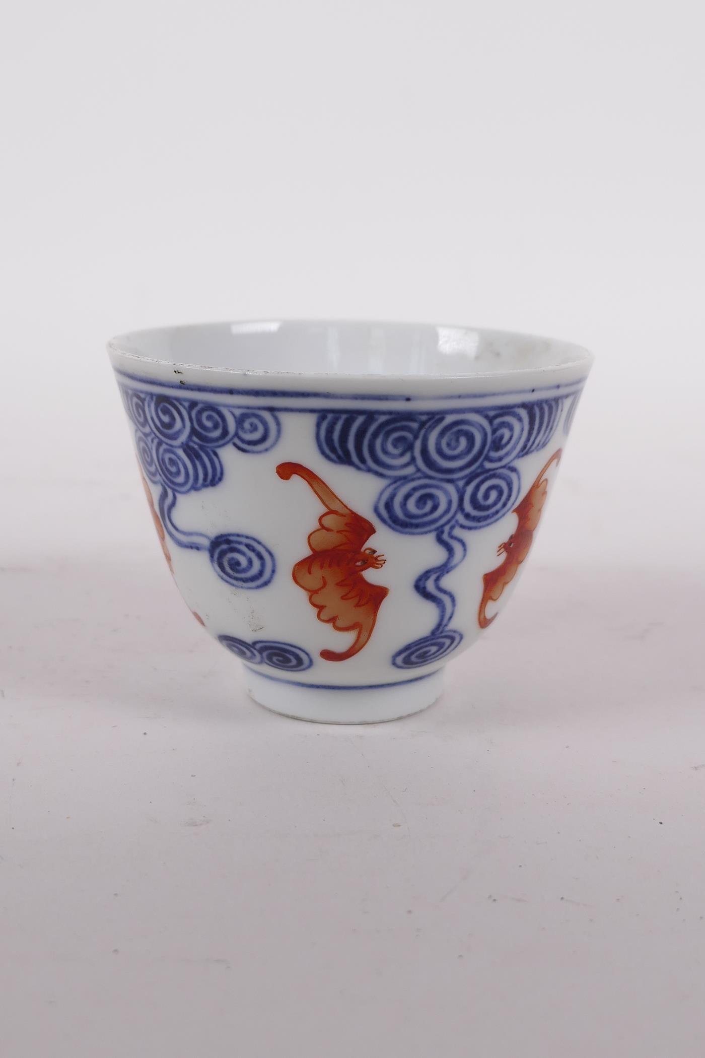 A Chinese blue and white porcelain tea bowl with iron red bat decoration, Quing six character mark - Image 3 of 5