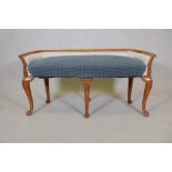 A late C19th Continental beechwood window seat, with carved decoration and shaped back, raised on