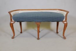 A late C19th Continental beechwood window seat, with carved decoration and shaped back, raised on