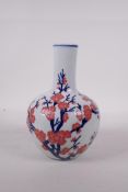 A Chinese blue and white porcelain bottle vase with blossom decoration highlighted with pink enamel,