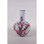A Chinese blue and white porcelain bottle vase with blossom decoration highlighted with pink enamel,