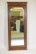 A late C19th Continental burr walnut wall mirror with ebonised moulded slip and detail, 64" x 27"