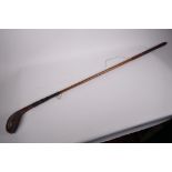 A vintage hickory handled gold club, the driver head marked 'Auchterlanie', 41" long
