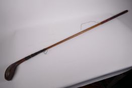 A vintage hickory handled gold club, the driver head marked 'Auchterlanie', 41" long