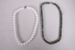 A green hardstone bead necklace and a white ceramic bead necklace, longest 19"