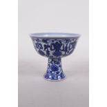 A Ming style blue and white porcelain stem cup with lotus flower decoration, six character mark to