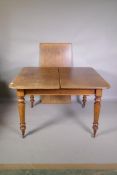 A Victorian mahogany drawleaf dining table with extra leaf, raised on turned supports and brass