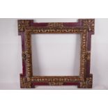 A carved giltwood and polychrome decorated picture frame with extended corners, 13" x 12" rebate