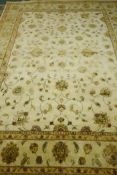 A contemporary silk and wool mix knotted carpet with oriental design in a muted palette, 12ft x 9ft