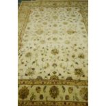 A contemporary silk and wool mix knotted carpet with oriental design in a muted palette, 12ft x 9ft