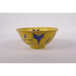 A yellow ground porcelain rice bowl with blue scrolling floral decoration, six character mark to